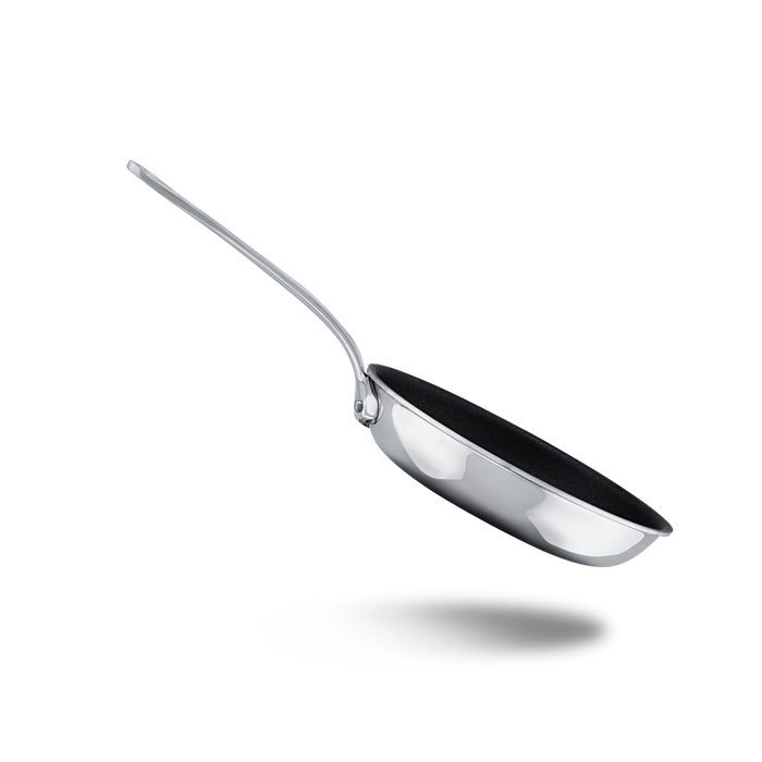 Mauviel M'COOK 5-ply nonstick frying pan with cast stainless steel handle, black cooking surface, and stainless steel rim.