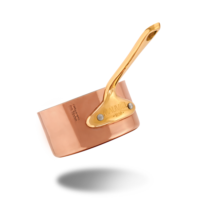 Mauviel M'MINIS copper sauce pan with brass handles, 3.5-inch diameter, showcasing polished copper surface and sturdy handles.