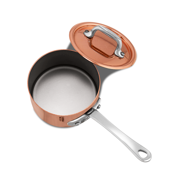 Mauviel M'MINIS copper sauce pan with stainless steel handles and lid, 0.32-quart capacity, ideal for small sauces and heating.