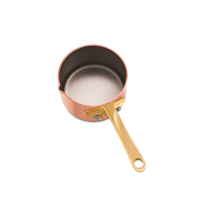 Mauviel M'MINIS copper sauce pan with brass handle and pouring spout, 2.7-inch diameter, suitable for precise cooking and sauce preparation.