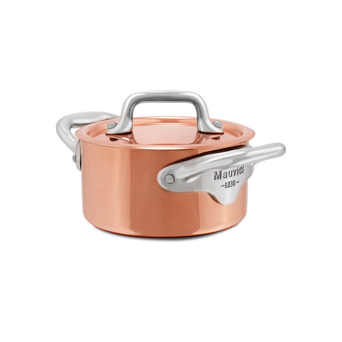 Mauviel M'MINIS copper stewpan with stainless steel handles, 0.34-quart capacity, showcasing polished copper surface and handles.