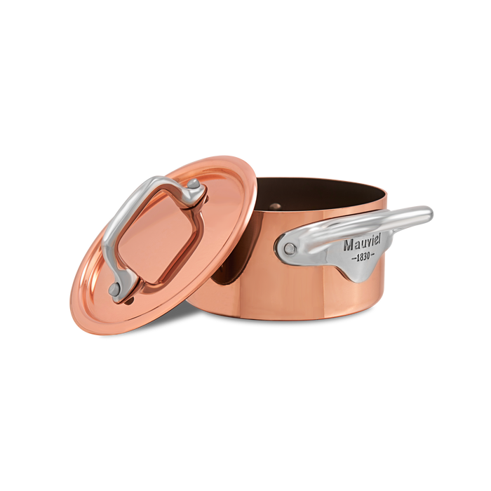 Mauviel M'MINIS copper stewpan with stainless steel handles, 0.34-quart capacity, showcasing polished copper surface and sturdy handles.