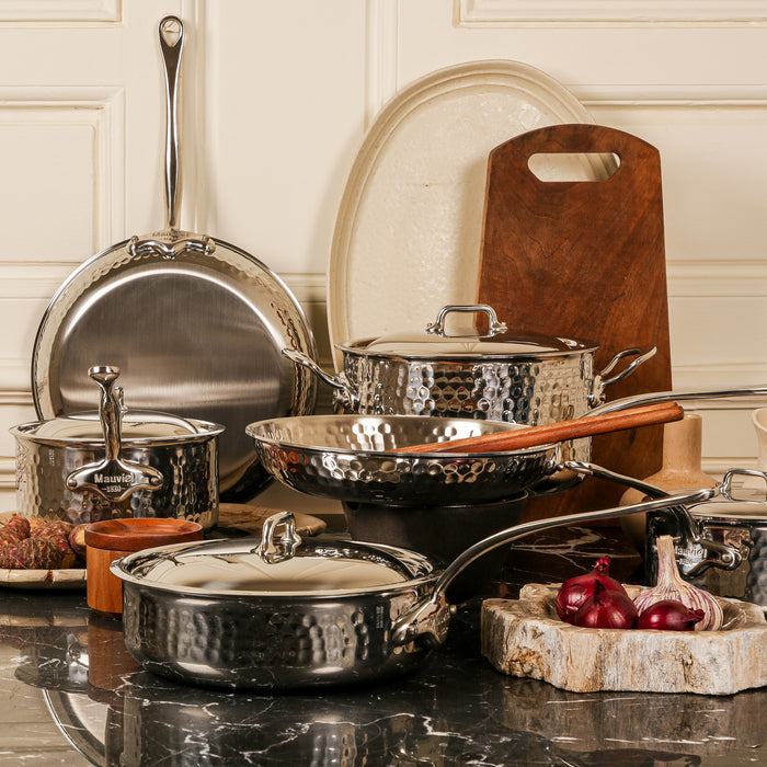 Mauviel M'ELITE hammered 6-quart stainless steel rondeau with lid and cast stainless steel handles, ideal for cooking and braising.