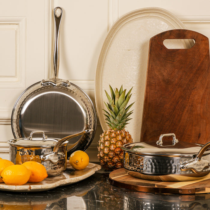Mauviel M'MINIS hammered 5-ply stainless steel sauce pan with cast stainless steel handles, 0.4-quart capacity.