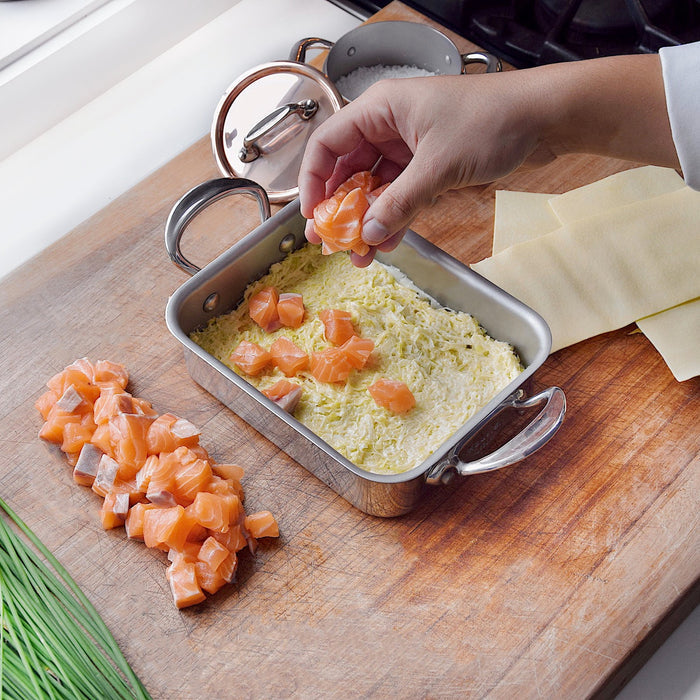 Mauviel M'Minis stainless steel roasting pan measuring 5.5 x 3.9 inches, ideal for small roasted dishes.