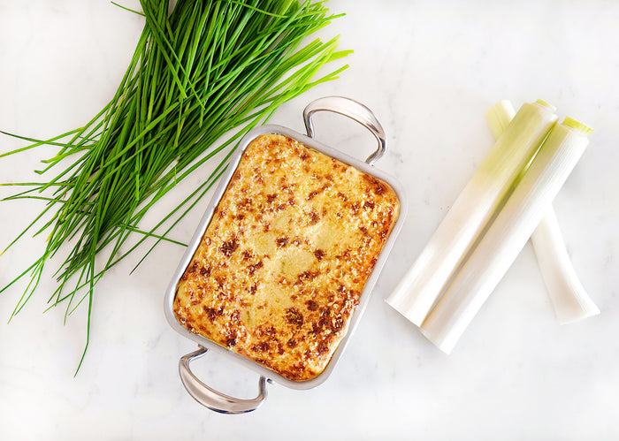Mauviel M'Minis stainless steel roasting pan, 5.5 x 3.9 inches, ideal for small roasts and baking, shown on a kitchen countertop.