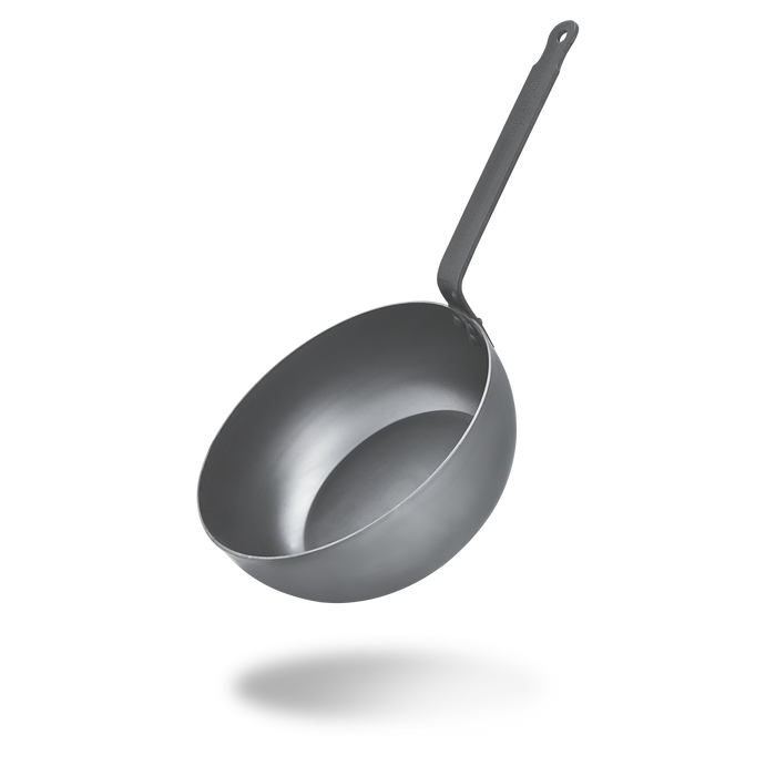 Mauviel M'STEEL black carbon steel chef pan with iron handle, shown from a top-down view, highlighting its round shape and sturdy handle.